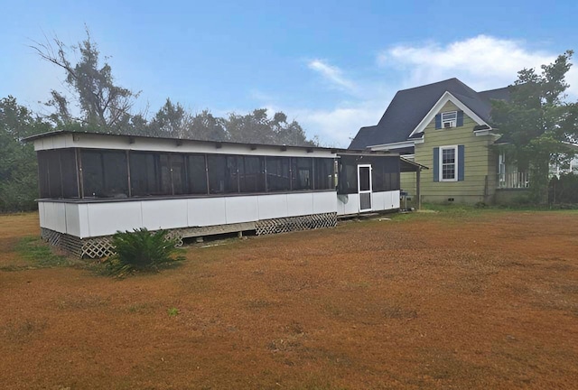 rear view of property with crawl space and a sunroom