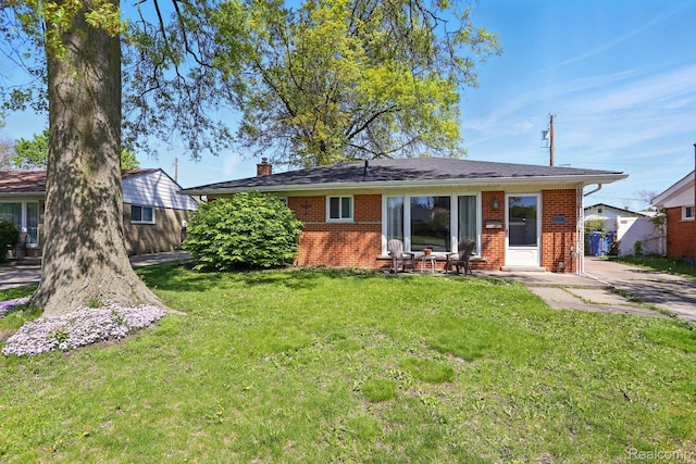 26830 Constance St, Dearborn Heights, MI 48127 - rear view of property with brick siding, a chimney, and a lawn
