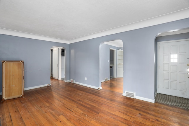 11248 Kennebec, Detroit, MI 48205 - empty room with arched walkways, baseboards, hardwood / wood-style flooring, and visible vents