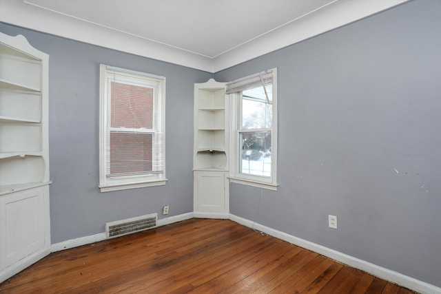 11248 Kennebec, Detroit, MI 48205 - unfurnished room with visible vents, baseboards, and dark wood-type flooring