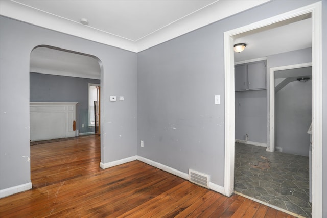 11248 Kennebec, Detroit, MI 48205 - unfurnished room with arched walkways, baseboards, visible vents, and hardwood / wood-style flooring