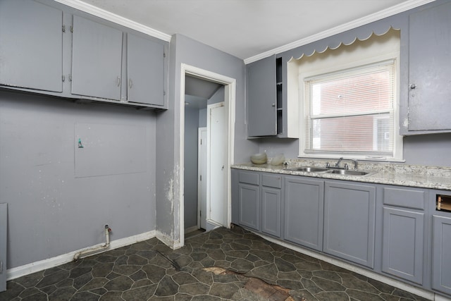 11248 Kennebec, Detroit, MI 48205 - kitchen featuring baseboards, light countertops, gray cabinets, a sink, and stone finish flooring