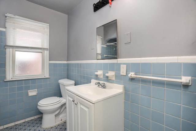 11248 Kennebec, Detroit, MI 48205 - bathroom featuring wainscoting, vanity, toilet, tile patterned floors, and tile walls