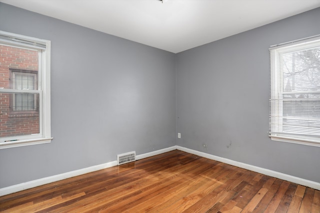 11248 Kennebec, Detroit, MI 48205 - empty room featuring wood-type flooring, baseboards, visible vents, and a healthy amount of sunlight