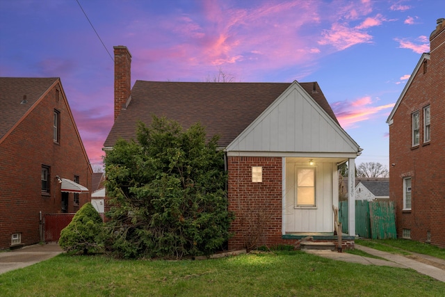 11248 Kennebec, Detroit, MI 48205 - bungalow featuring board and batten siding, fence, a chimney, and a front yard