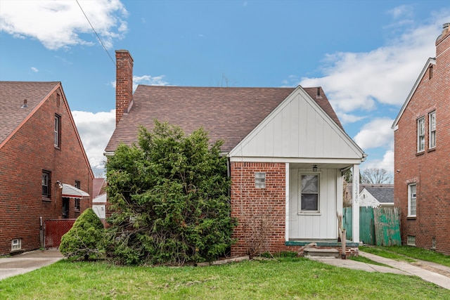 11248 Kennebec, Detroit, MI 48205 - bungalow-style house with fence, a shingled roof, a front lawn, board and batten siding, and a chimney
