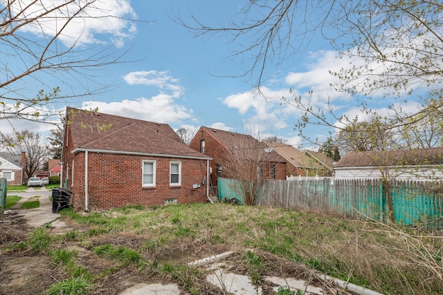 11248 Kennebec, Detroit, MI 48205 - back of house with brick siding, fence, and a shingled roof