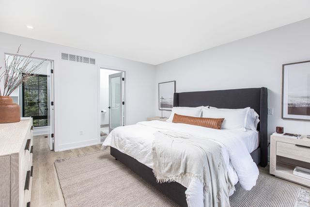 533 E Harrison Ave Unit 29, Royal Oak, MI 48067 - bedroom featuring baseboards, light wood-style flooring, and visible vents