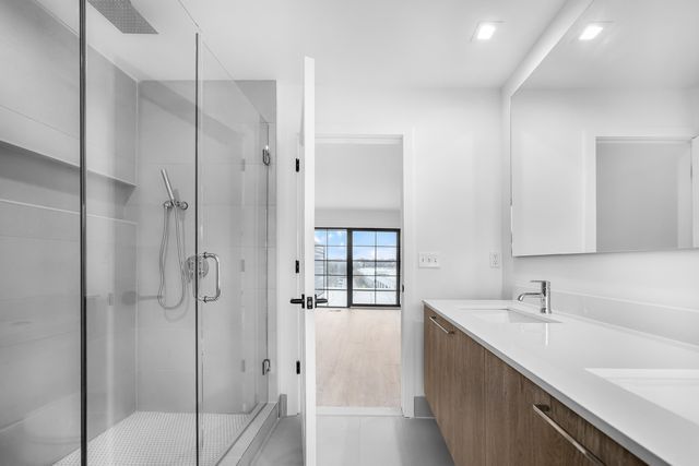 533 E Harrison Ave Unit 29, Royal Oak, MI 48067 - bathroom featuring visible vents, double vanity, recessed lighting, a sink, and a stall shower
