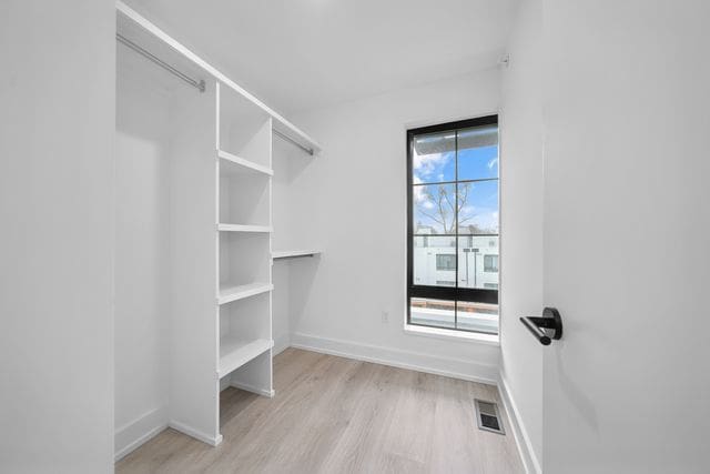 533 E Harrison Ave Unit 29, Royal Oak, MI 48067 - walk in closet with visible vents and light wood-style floors
