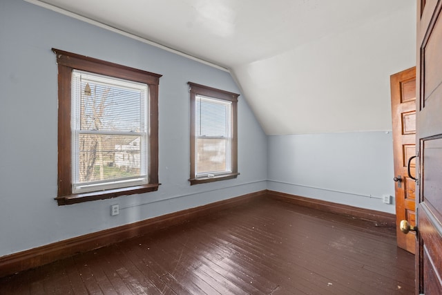 additional living space with wood-type flooring, baseboards, and lofted ceiling