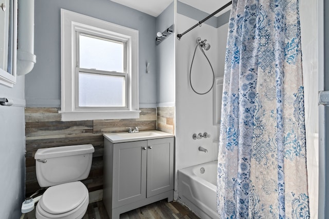 bathroom with toilet, vanity, and shower / bath combination with curtain