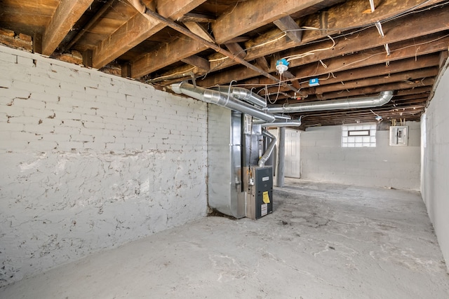 below grade area featuring electric panel and heating unit