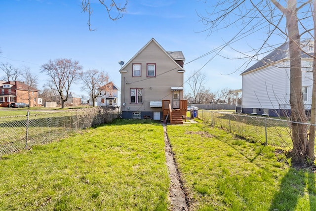 back of property featuring a yard and a fenced backyard