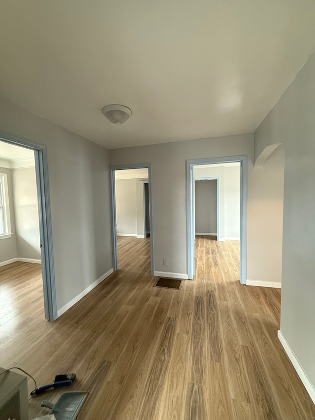 2651 Neibel St, Hamtramck, MI 48212 - empty room with arched walkways, baseboards, and wood finished floors