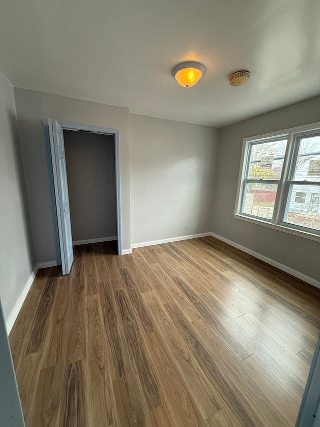 2651 Neibel St, Hamtramck, MI 48212 - unfurnished bedroom with a closet, baseboards, and wood finished floors