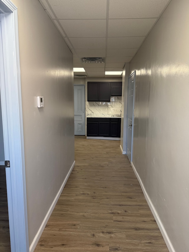 2651 Neibel St, Hamtramck, MI 48212 - hall featuring visible vents, baseboards, a drop ceiling, and wood finished floors