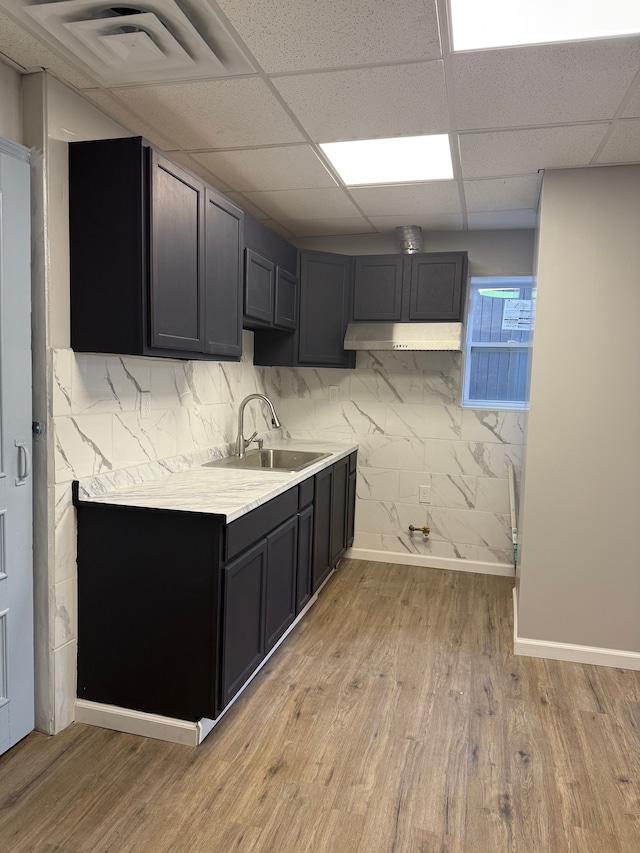 2651 Neibel St, Hamtramck, MI 48212 - kitchen with light wood-style flooring, light countertops, visible vents, a drop ceiling, and a sink