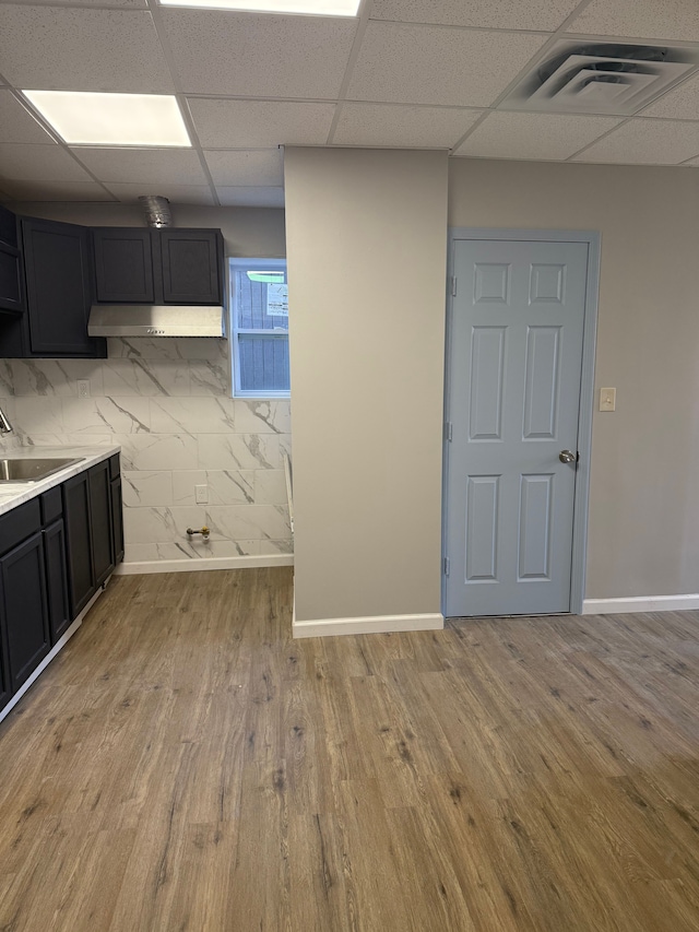 2651 Neibel St, Hamtramck, MI 48212 - interior space featuring a paneled ceiling, visible vents, wood finished floors, a sink, and baseboards