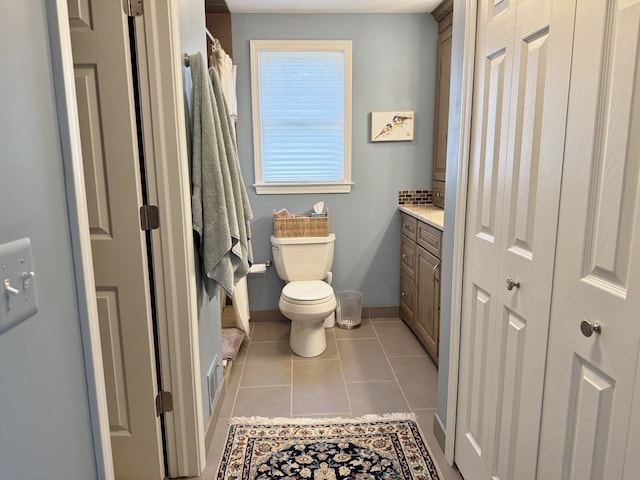 12131 Brandywine Dr, Brighton, MI 48114 - bathroom with baseboards, toilet, tile patterned flooring, and a shower with curtain
