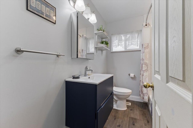 full bathroom with vanity, toilet, and wood finished floors