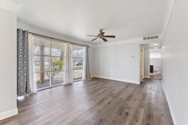unfurnished living room with visible vents, baseboards, a ceiling fan, and wood finished floors