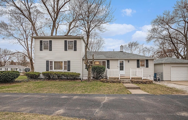 3804 Lincoln Ave, Saint Joseph, MI 49085 - view of front of home featuring an outdoor structure, a chimney, a detached garage, a front lawn, and aphalt driveway