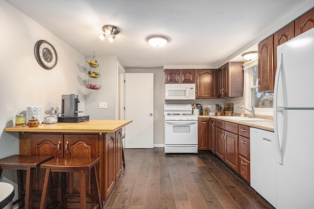3804 Lincoln Ave, Saint Joseph, MI 49085 - kitchen with light countertops, dark wood-style flooring, a sink, and white appliances