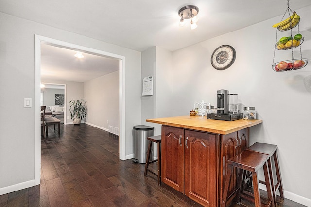 3804 Lincoln Ave, Saint Joseph, MI 49085 - bar featuring dark wood-type flooring, baseboards, and a dry bar
