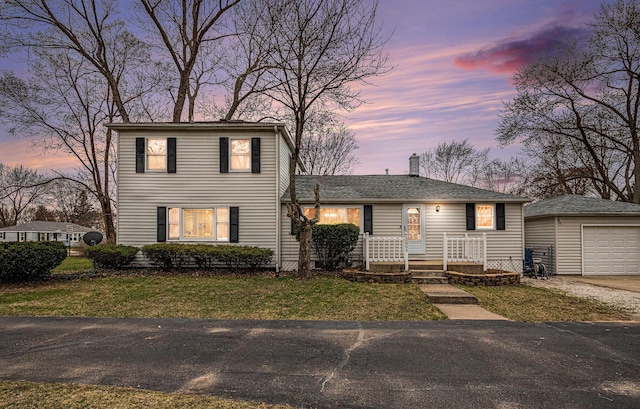 3804 Lincoln Ave, Saint Joseph, MI 49085 - view of front facade featuring a front yard, a garage, a chimney, aphalt driveway, and an outdoor structure