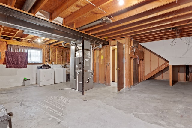 below grade area with washing machine and clothes dryer and heating unit
