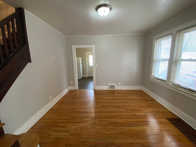 interior space featuring wood finished floors, visible vents, and baseboards