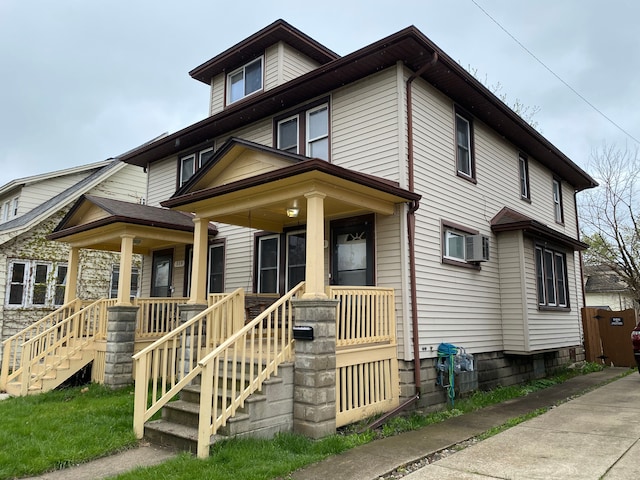 american foursquare style home featuring a porch