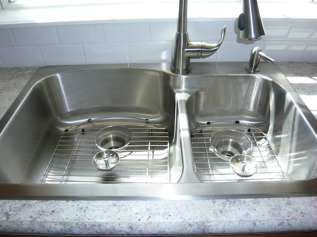 interior details with a sink and tasteful backsplash