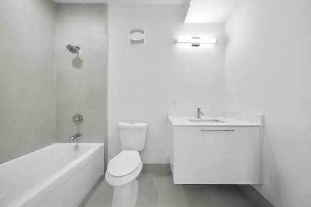 533 E Harrison Ave Unit 30, Royal Oak, MI 48067 - full bath with vanity, toilet, tile patterned floors, and  shower combination
