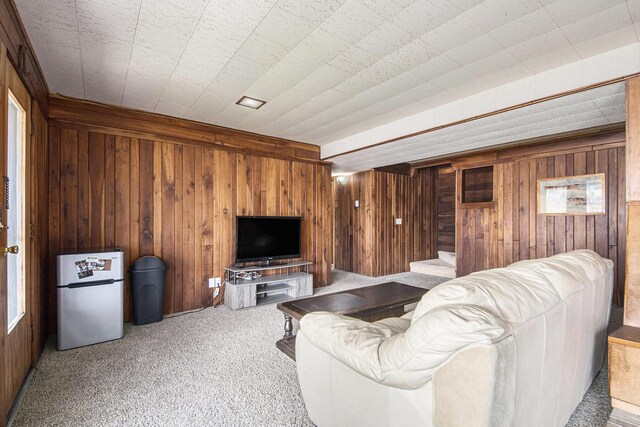 3942 Harmon Dr, Fremont, MI 49412 - living room with wooden walls, carpet, and stairs