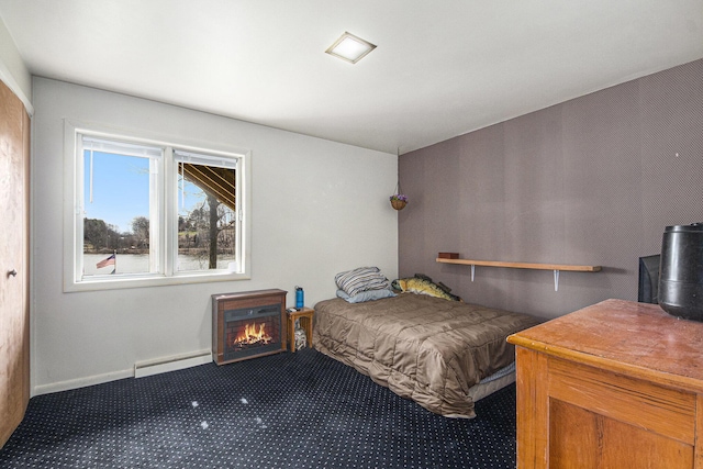 3942 Harmon Dr, Fremont, MI 49412 - carpeted bedroom with baseboard heating, a lit fireplace, and baseboards