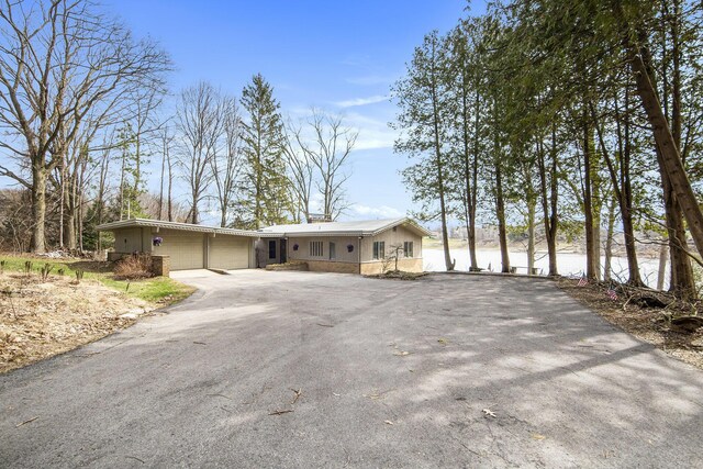 3942 Harmon Dr, Fremont, MI 49412 - single story home featuring an attached garage and aphalt driveway