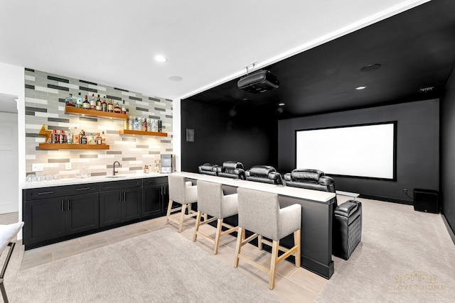 cinema with wet bar, a sink, and recessed lighting