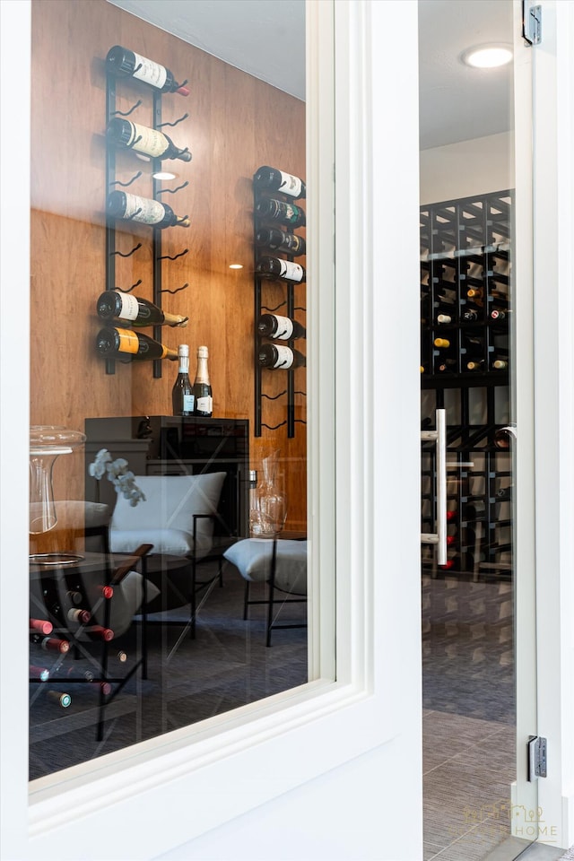 wine area featuring wood walls