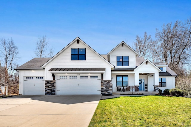 craftsman inspired home with a standing seam roof, stone siding, covered porch, a front lawn, and driveway