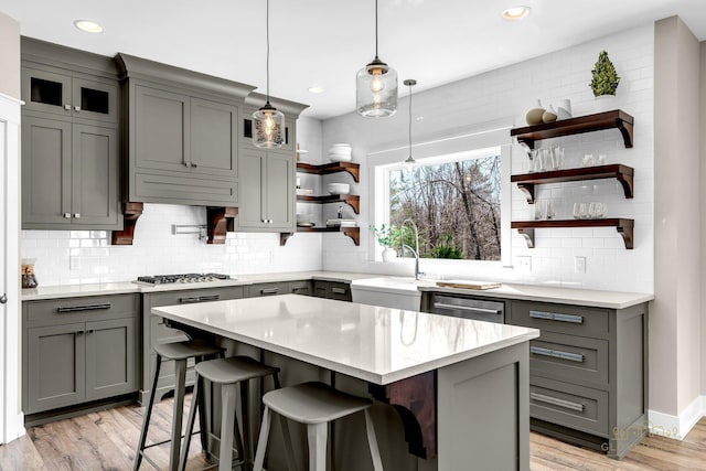 kitchen featuring recessed lighting, open shelves, gray cabinetry, decorative backsplash, and a sink