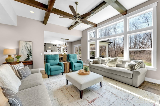sunroom with a chandelier, visible vents, beamed ceiling, and coffered ceiling