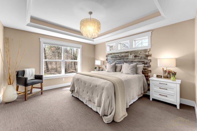 bedroom with a chandelier, multiple windows, baseboards, and a raised ceiling