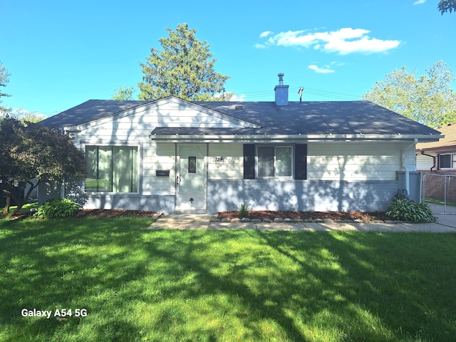 7541 Sloan St, Taylor, MI 48180 - back of house featuring a yard, fence, and a chimney