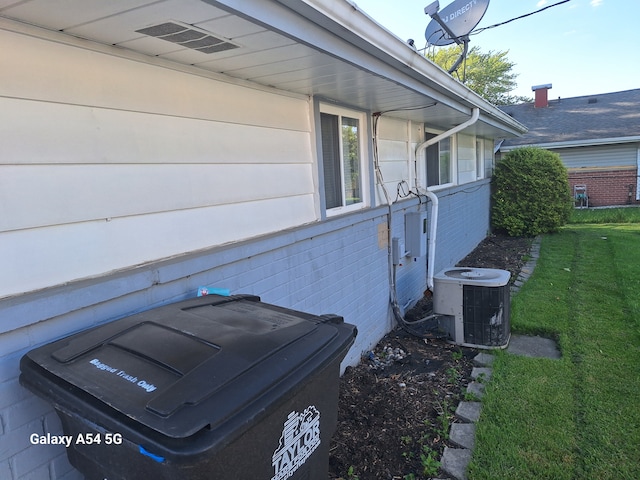 7541 Sloan St, Taylor, MI 48180 - view of side of property featuring central AC unit and a lawn