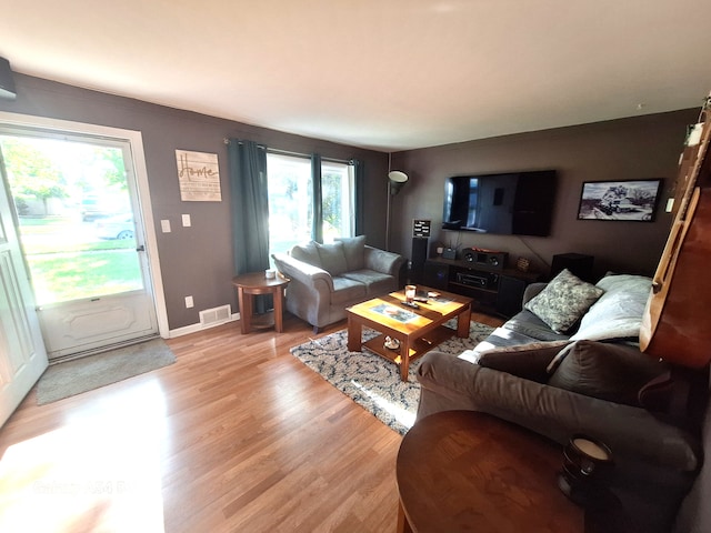 7541 Sloan St, Taylor, MI 48180 - living area with light wood-style floors, visible vents, and baseboards