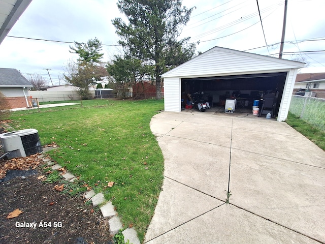 7541 Sloan St, Taylor, MI 48180 - view of yard featuring a garage, fence, and an outbuilding