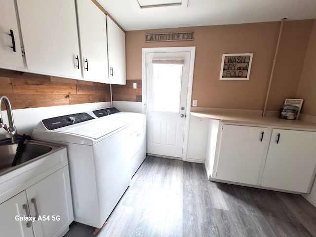 7541 Sloan St, Taylor, MI 48180 - laundry room featuring light wood-style flooring, a sink, wooden walls, cabinet space, and washing machine and clothes dryer