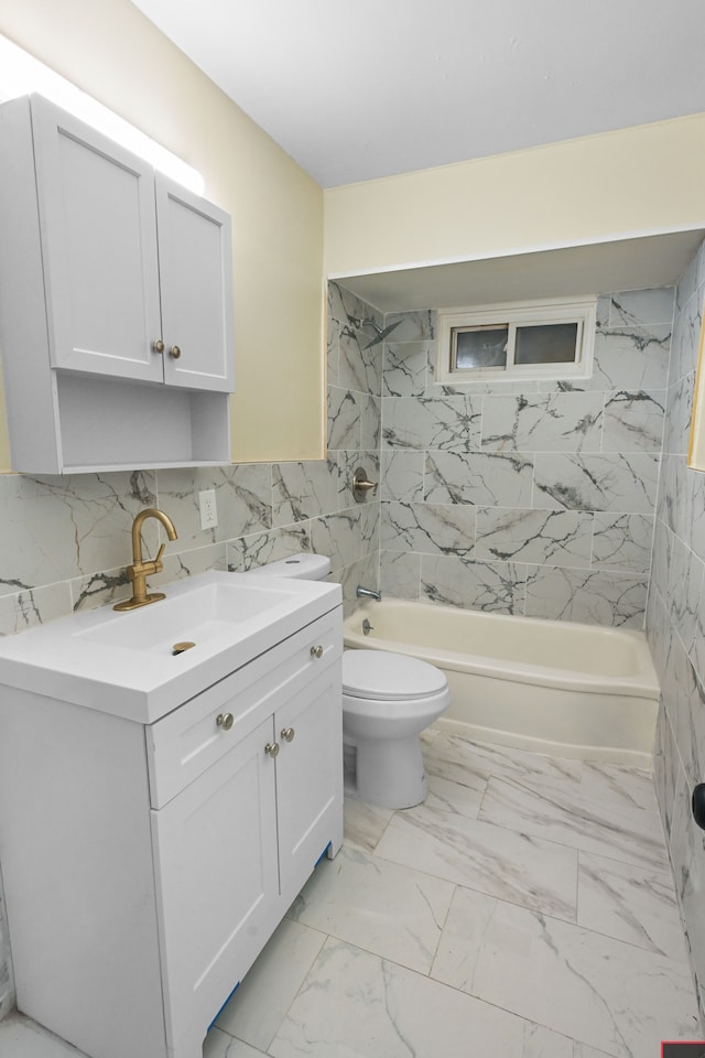 bathroom with tile walls, vanity, shower / bathtub combination, toilet, and marble finish floor